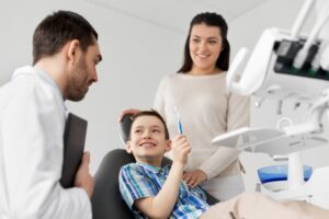 a young boy with his mom at the dentist office