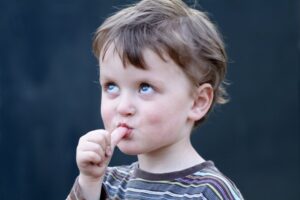 Boy sucking thumb.
