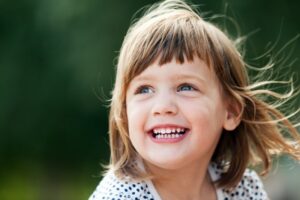 Little girl with big smile.